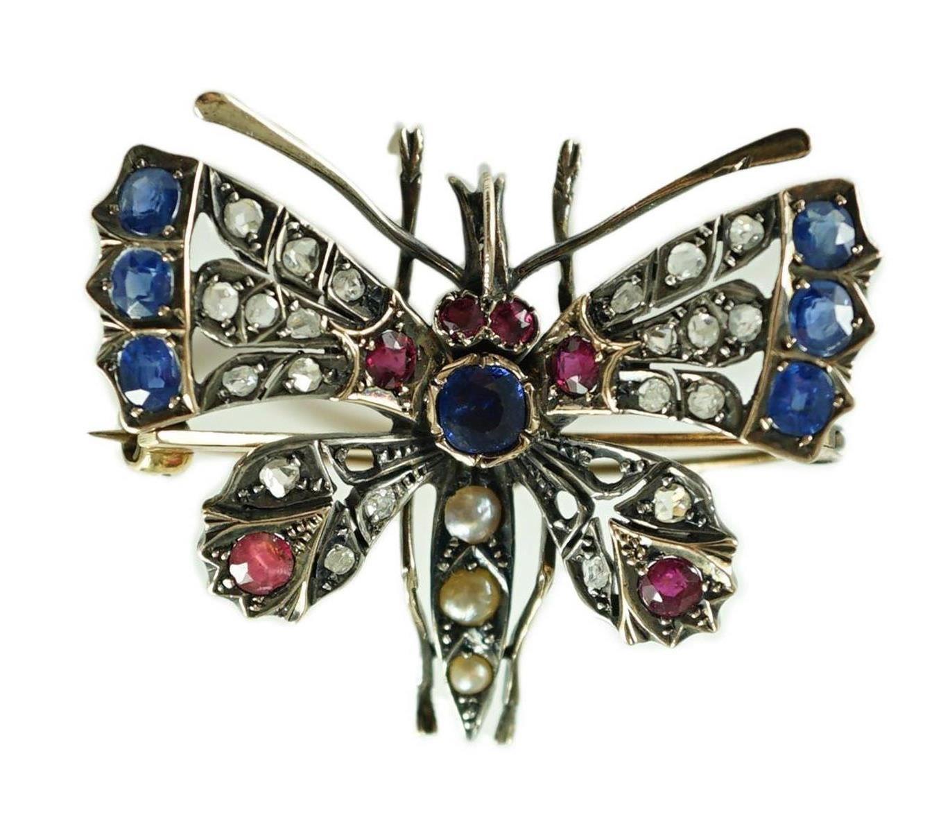 A Victorian gold and silver, diamond, ruby, sapphire and split pearl set butterfly brooch